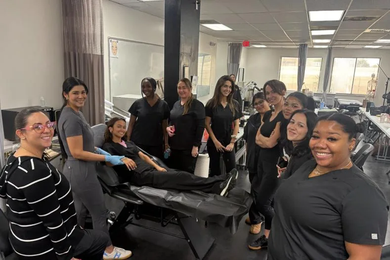 Esthetics students and their instructor during a waxing class at Hyphen Beauty + Massage School in Winter Park, FL