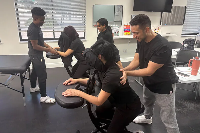Massage students practicing chair massage