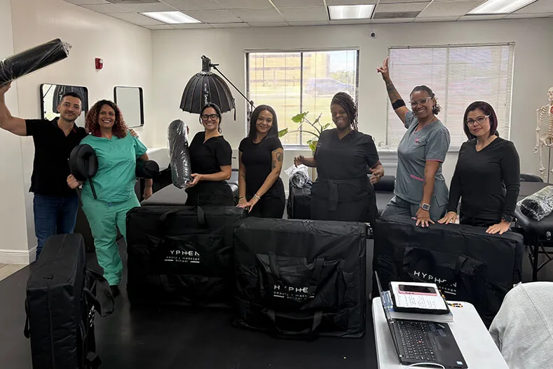 Massage students with their massage kits